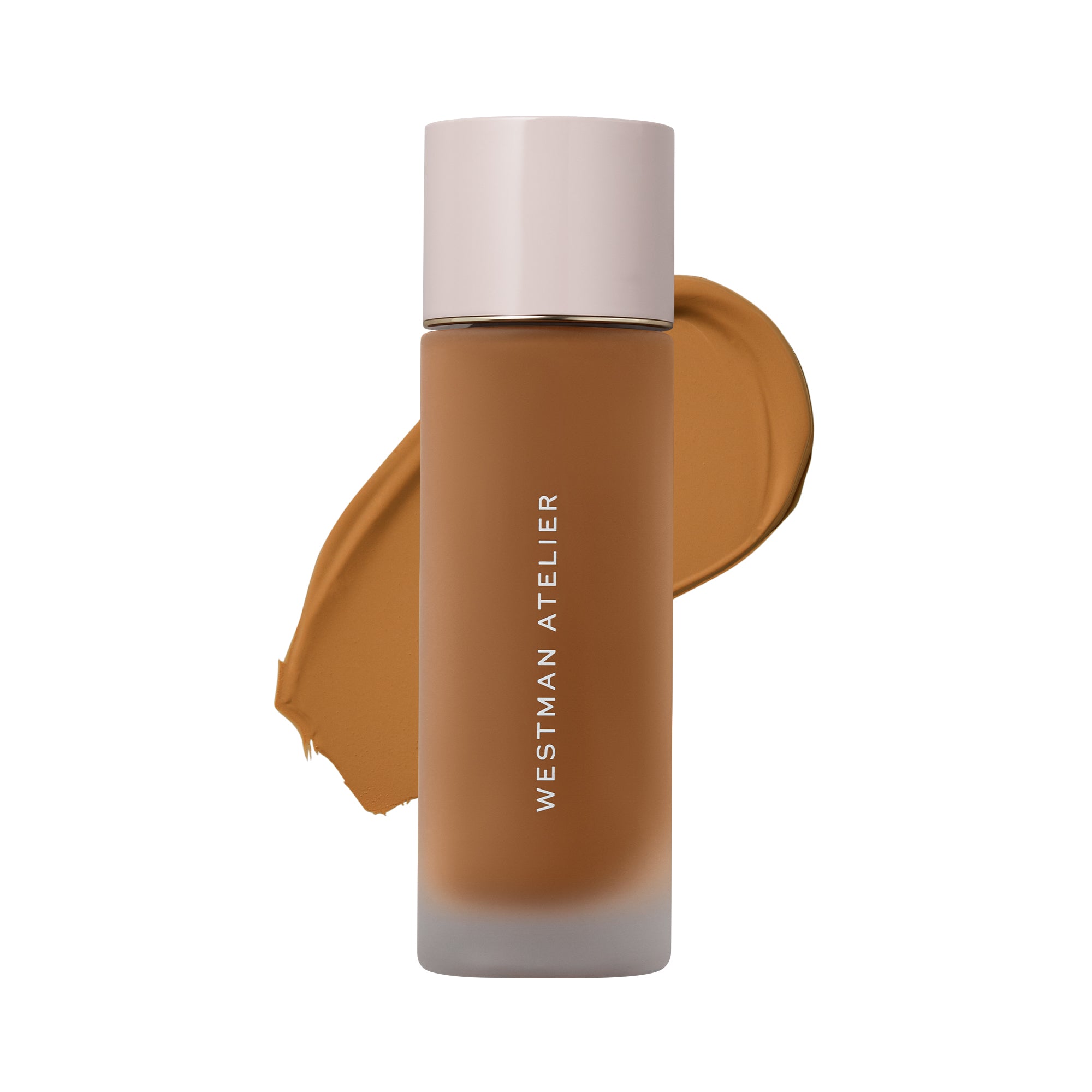 Westman Atelier liquid foundation in a frosted glass bottle with a pale pink cap, shown against a white background with a brown makeup swatch behind it.