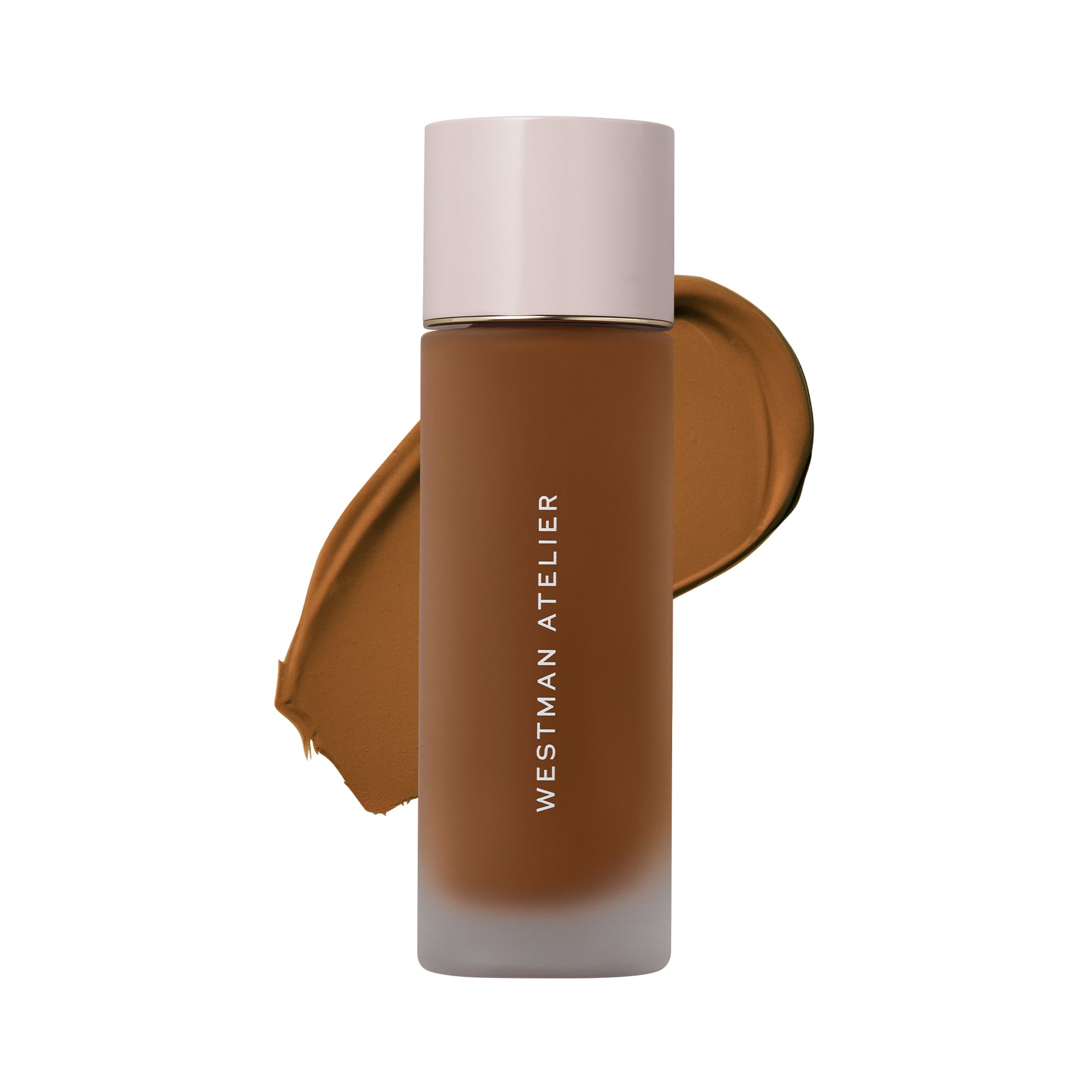 Westman Atelier liquid foundation in a frosted glass bottle with a pale pink cap, shown against a white background with a brown makeup swatch behind it.