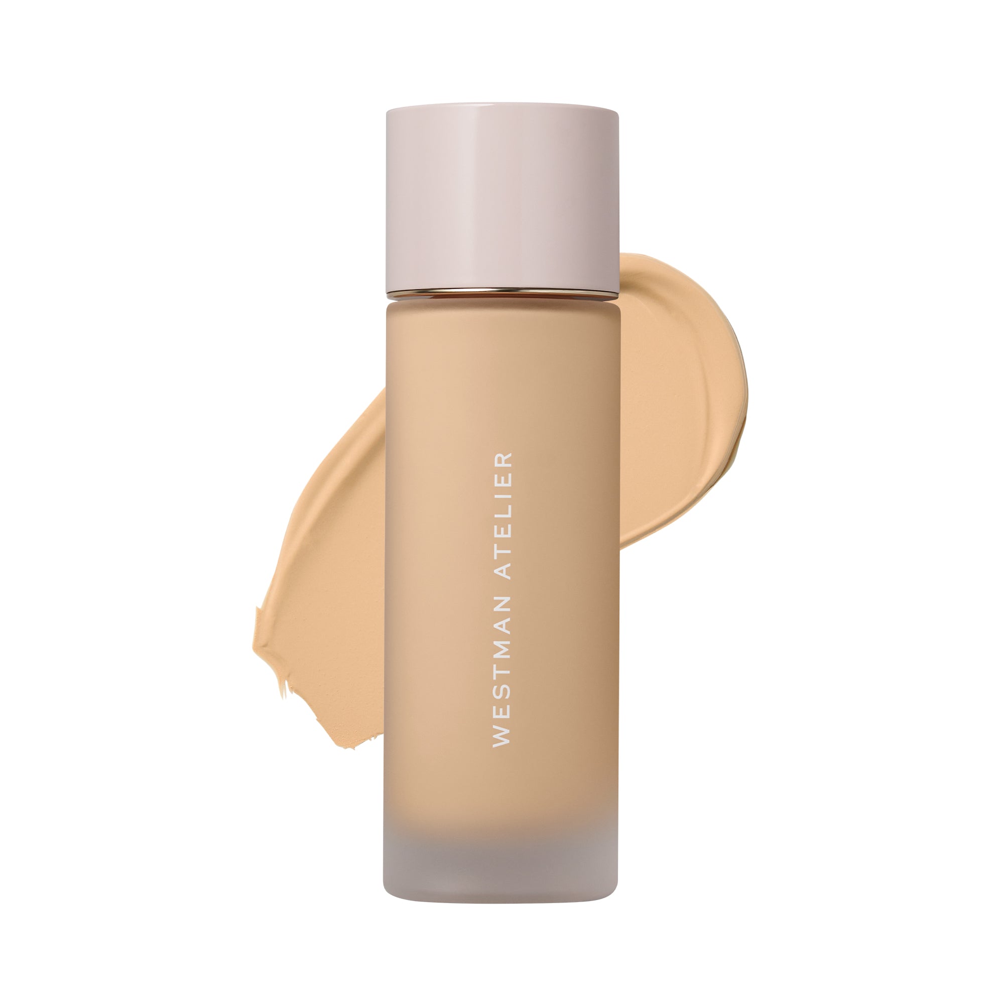 Westman Atelier liquid foundation in a frosted glass bottle with a pale pink cap, shown with a beige foundation swatch behind it on a white background.