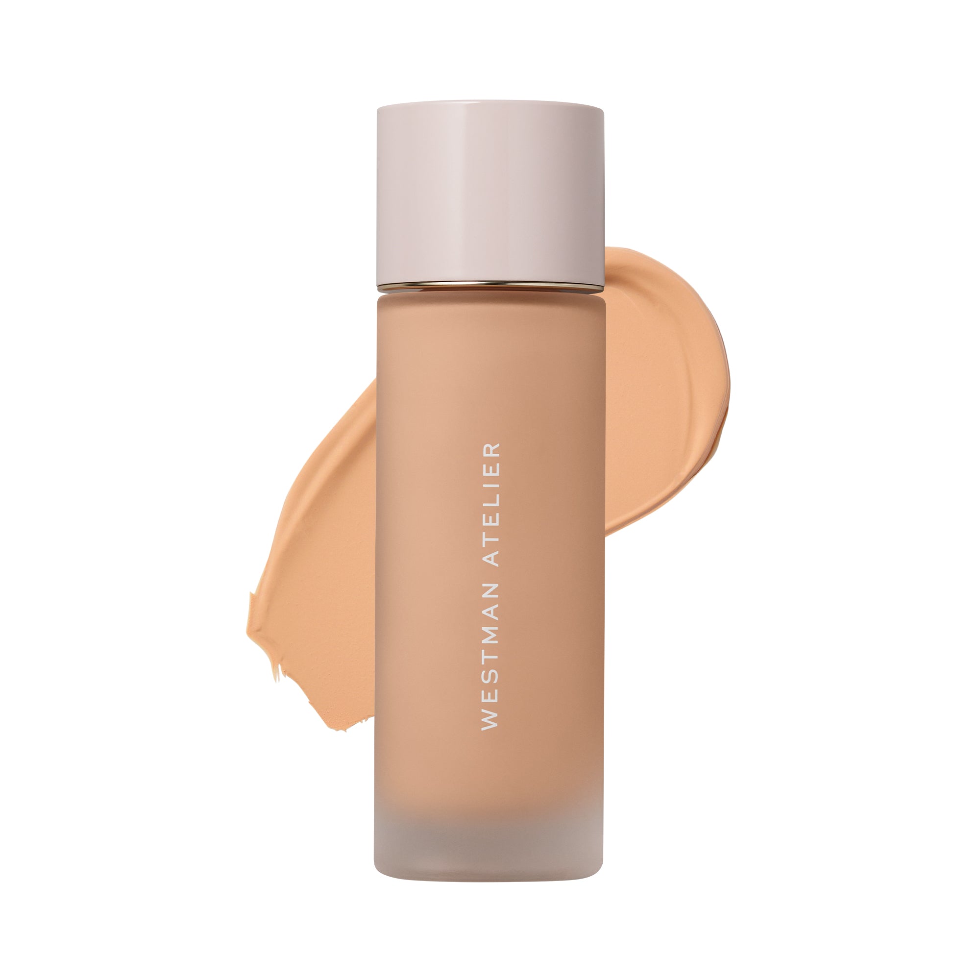 Westman Atelier liquid foundation in a frosted glass bottle with a pale pink cap, shown against a white background with a beige foundation swatch behind it.