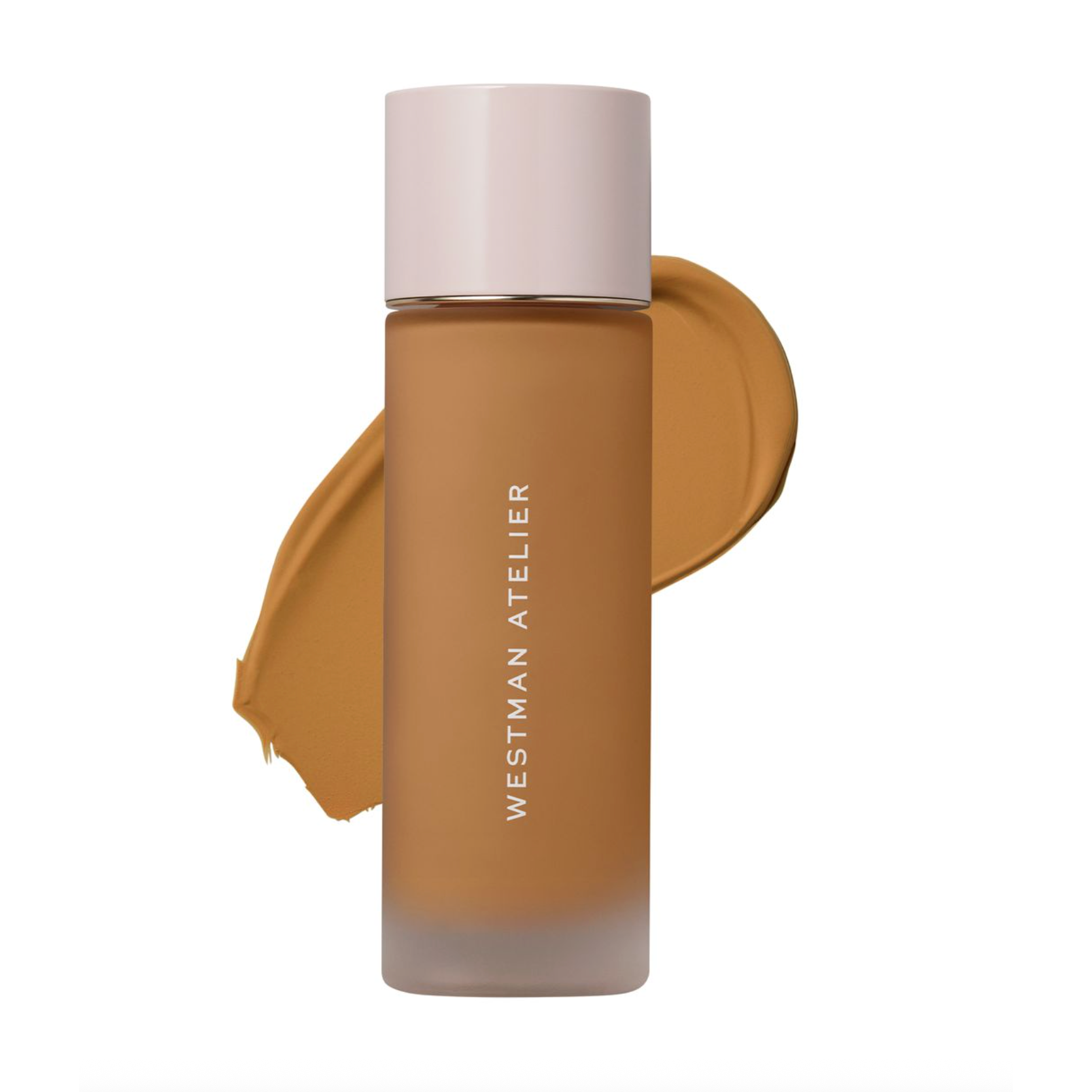 Westman Atelier liquid foundation in a frosted glass bottle with a pale pink cap, shown in front of a warm tan makeup swatch on a white background.