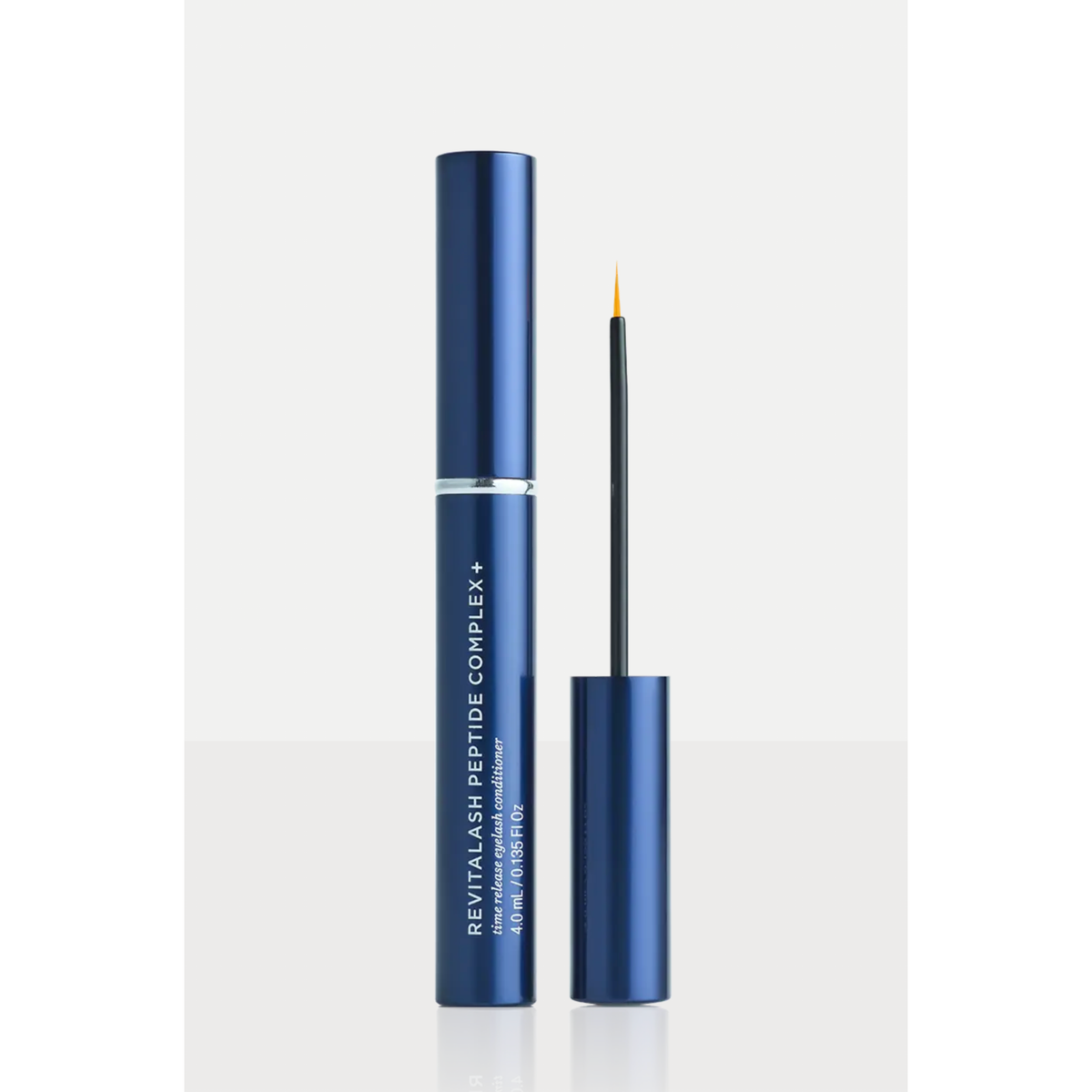 Revitalash Peptide Complex+ eyeliner in a metallic navy blue tube, shown with the applicator wand and cap on a clean white background.
