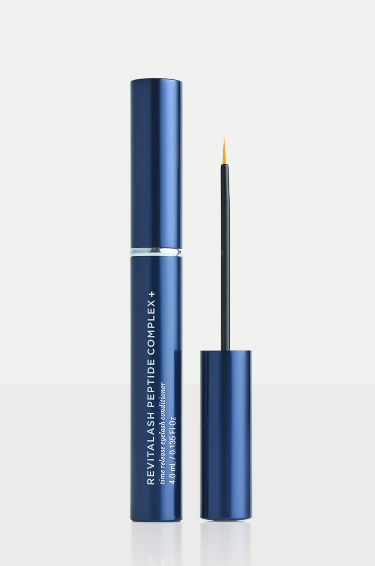 Revitalash Peptide Complex+ eyeliner in a metallic navy blue tube, shown with the applicator wand and cap on a clean white background.